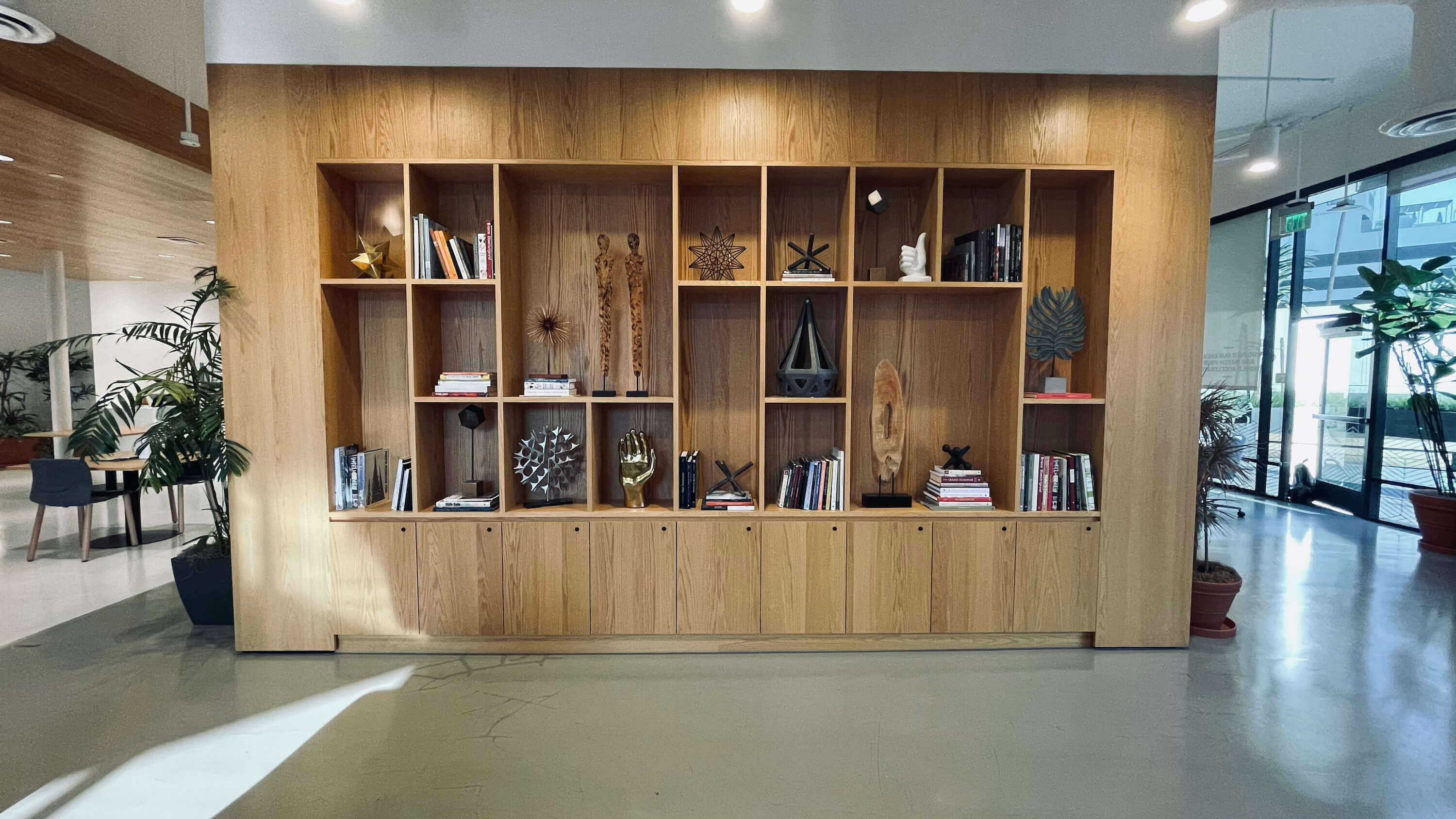 Freestanding bookcase divider on the Main Floor at 1800 Vine St with curated objects and plants