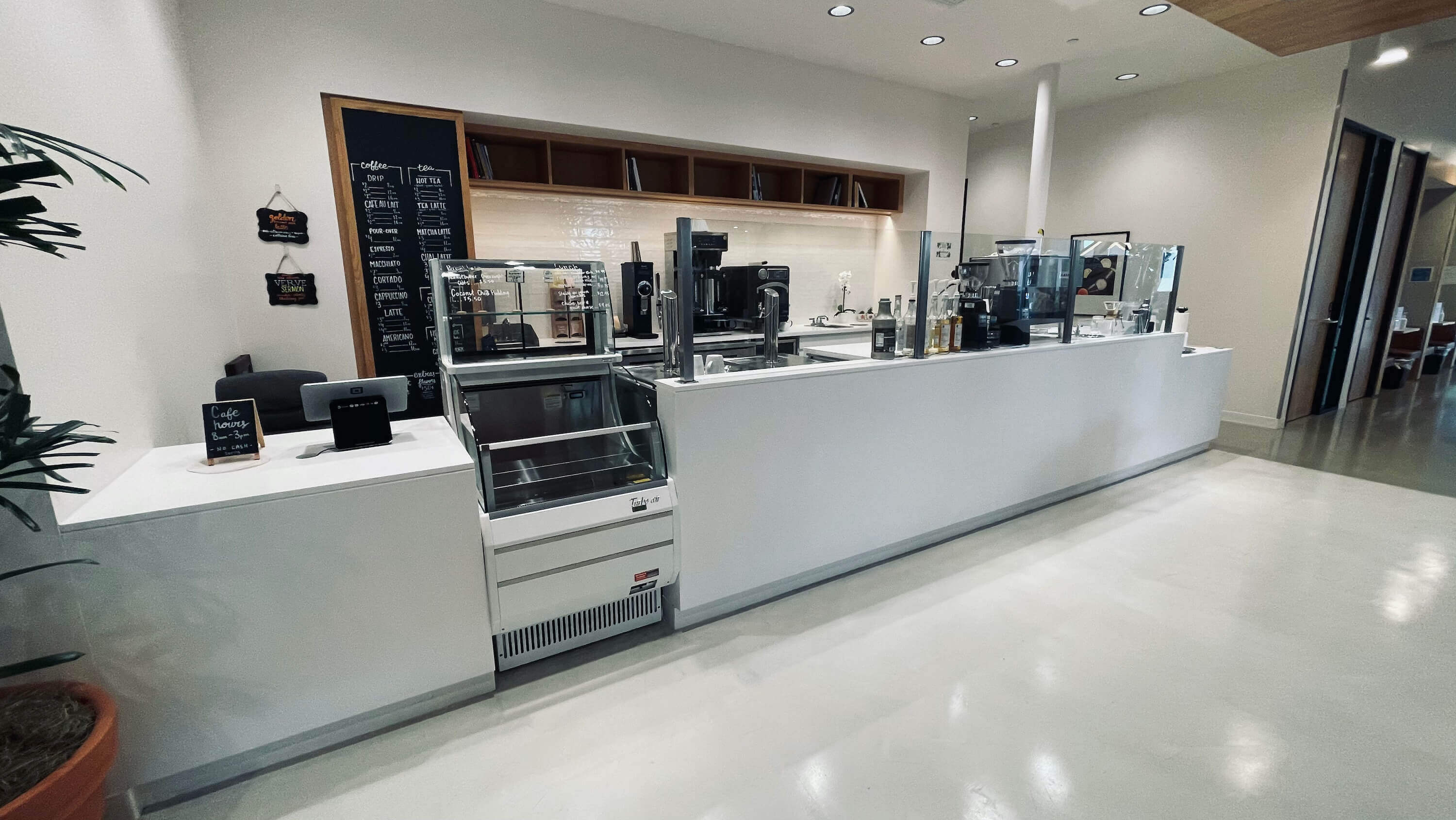 Coffee bar on the Main Floor at 1800 Vine St with espresso equipment and chalkboard menu