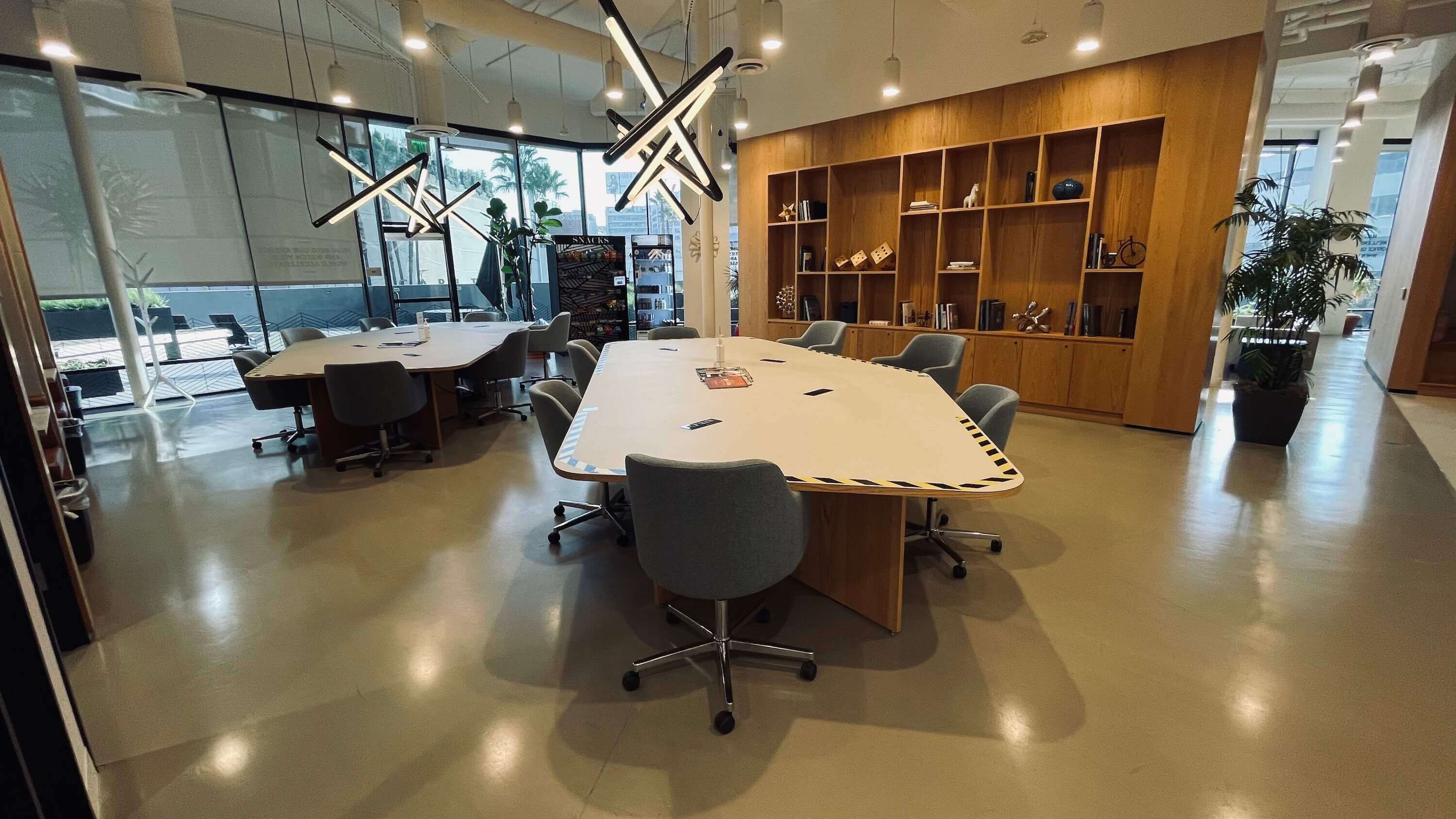 Conference table area on the Main Floor at 1800 Vine St with star pendant lights and floor-to-ceiling windows
