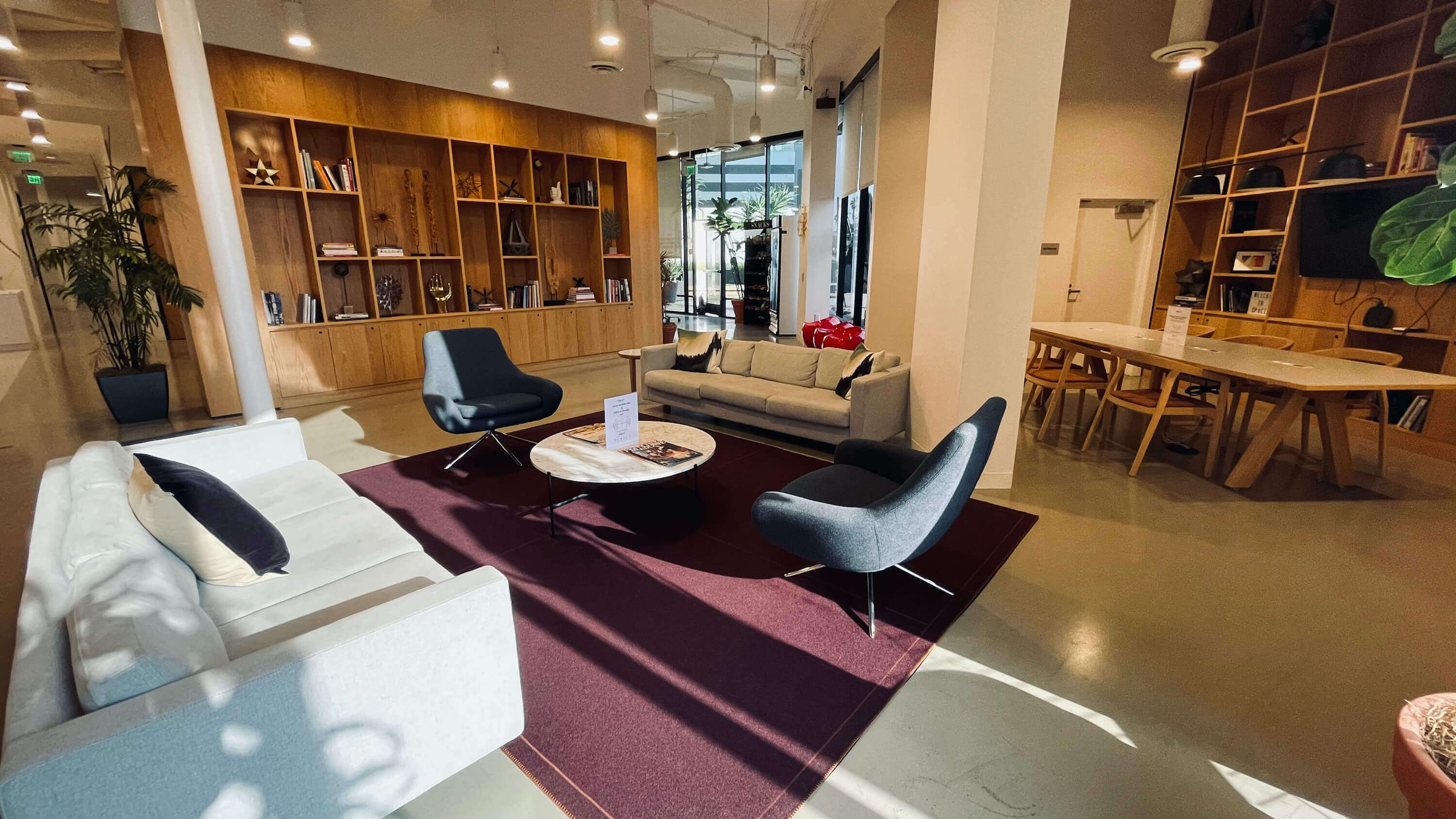 Full lounge area on the Main Floor at 1800 Vine St with sofas, bookshelves, and warm lighting