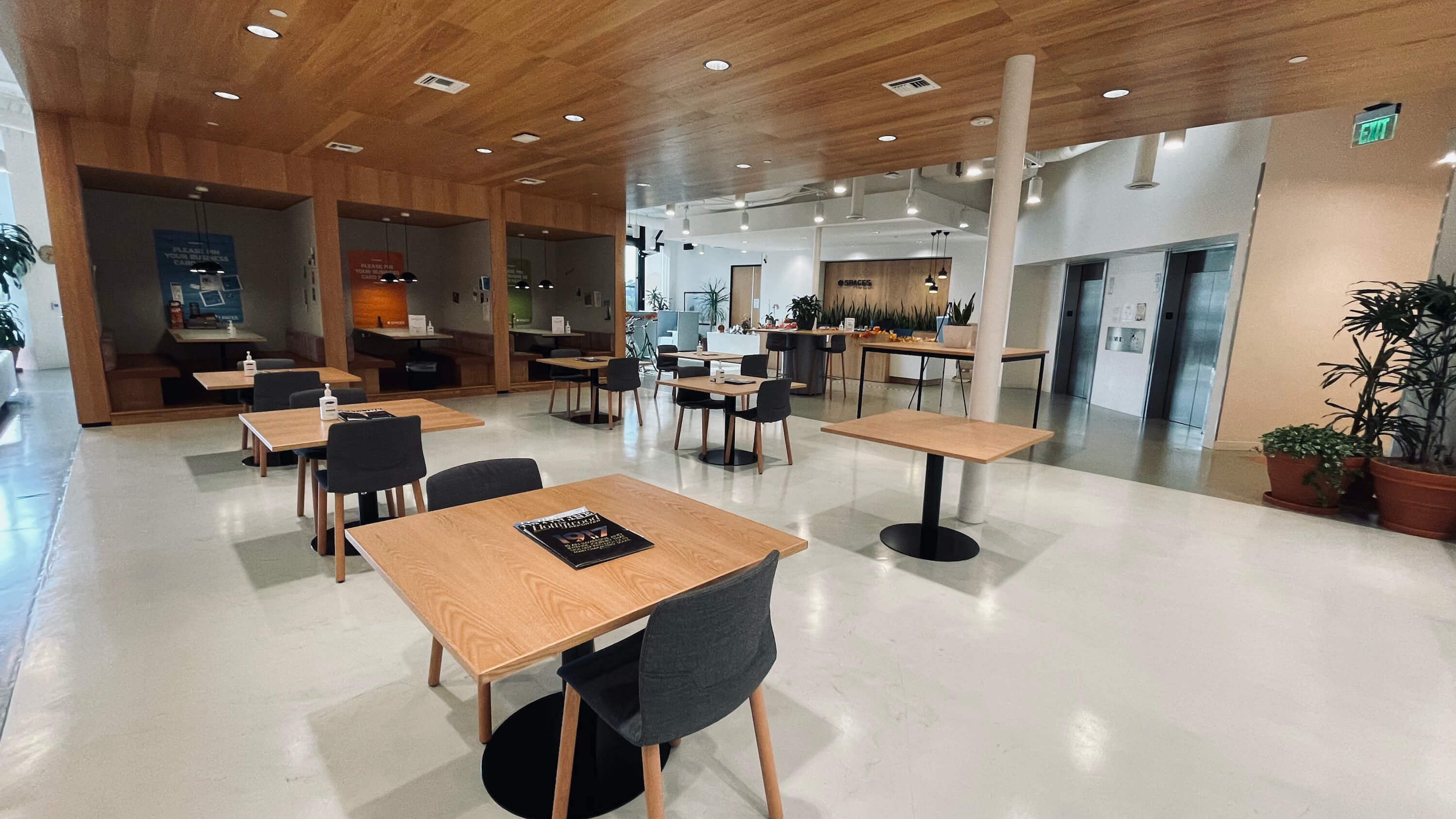 Lounge and conference tables on the Main Floor at 1800 Vine St with geometric pendant lighting