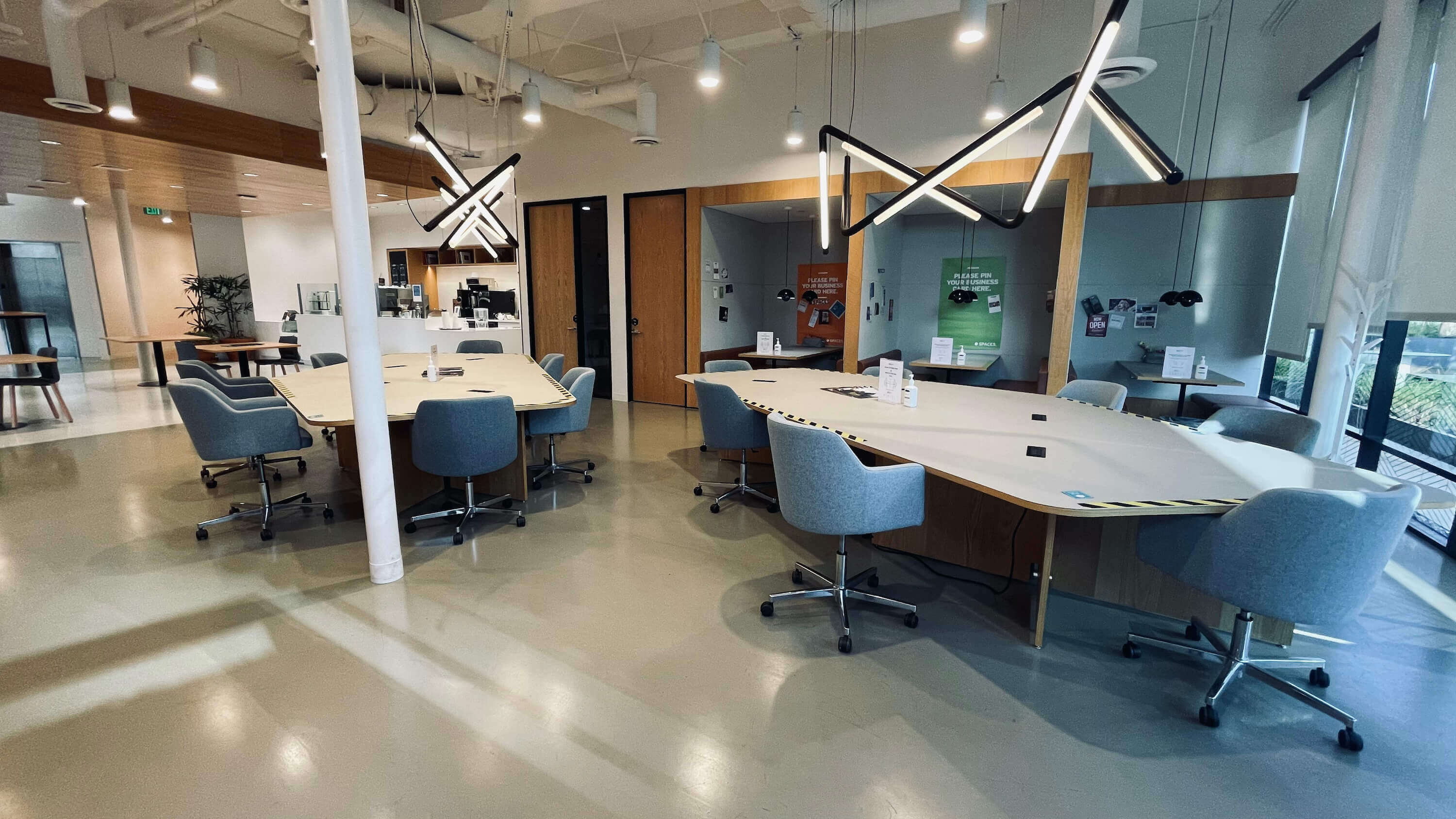Open table area on the Main Floor at 1800 Vine St with X-shaped pendant lighting