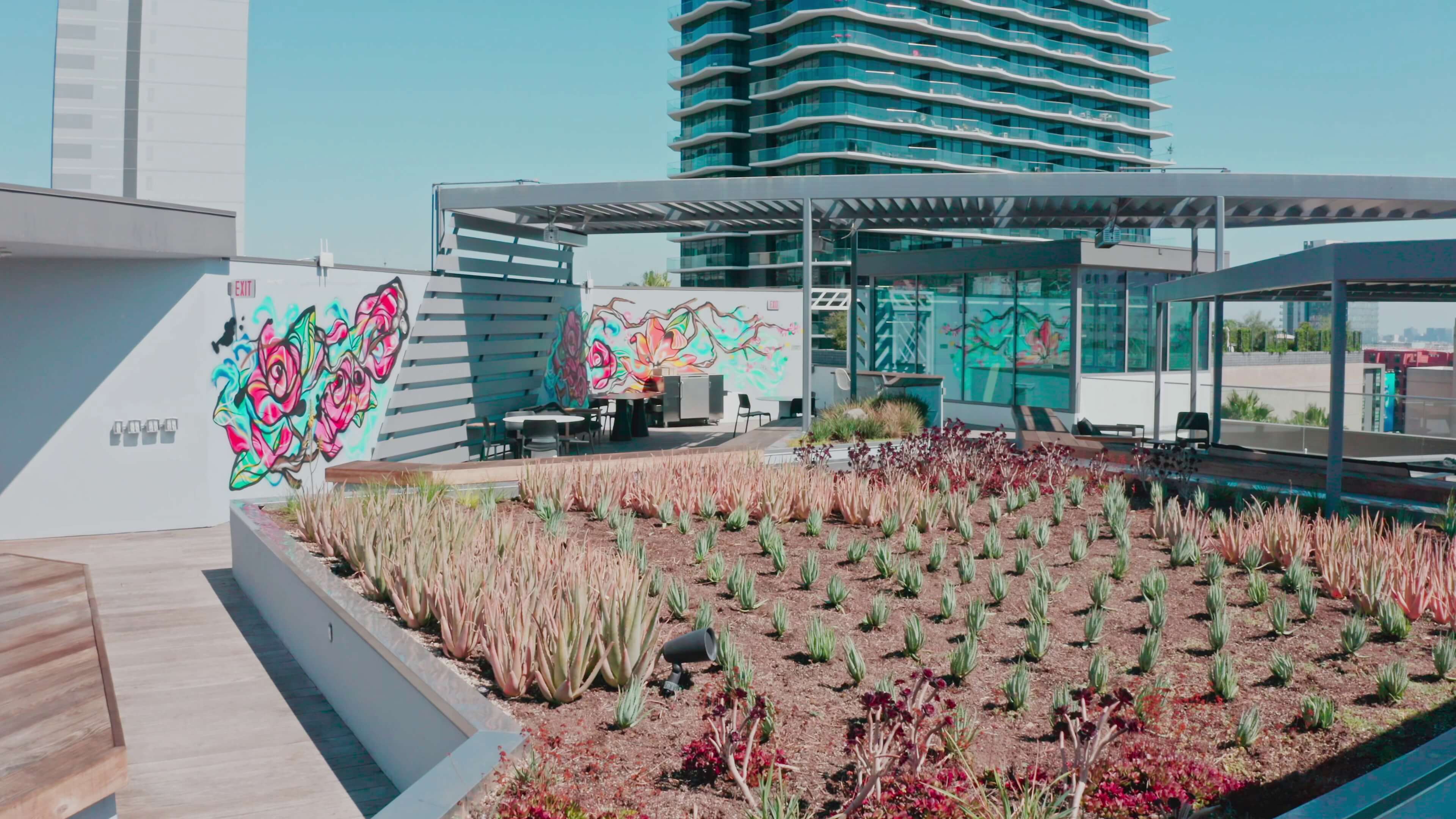 Aerial view of rooftop garden beds and louvered pergola canopy at 1800 Vine St