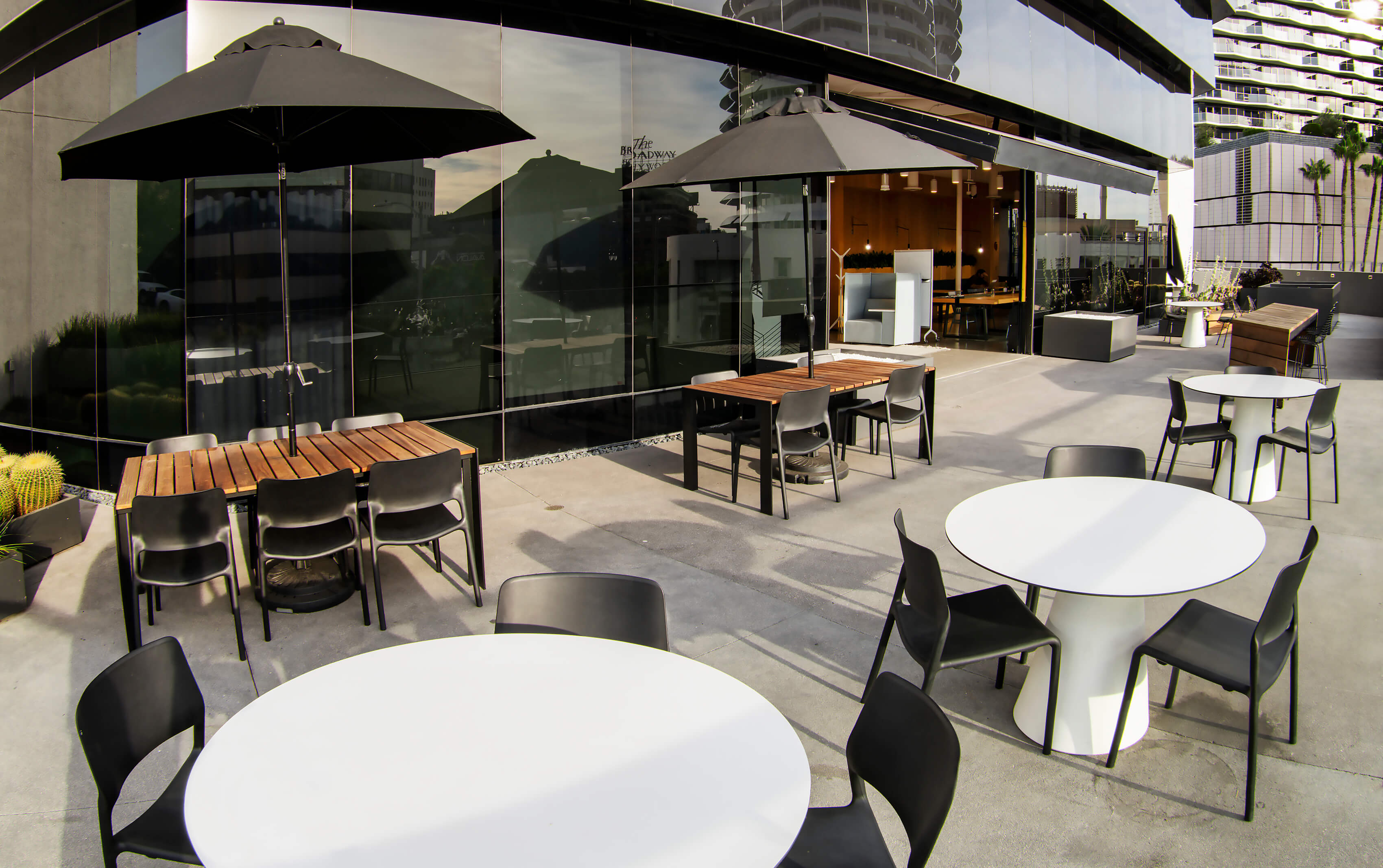 Yucca St. Patio from a side angle showing the reflective glass facade at 1800 Vine St